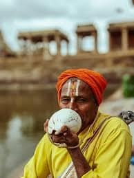 Blowing Of Shankh: A Must Ritual At The End Of Every Worship 2 man-blowing-of-shankh